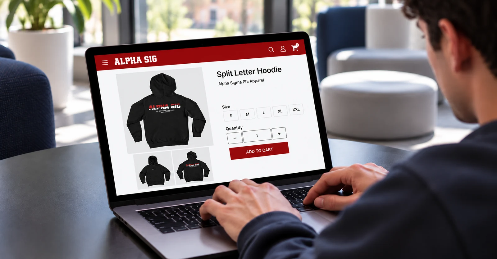 Someone shopping an Alpha Sig group storefront on a laptop