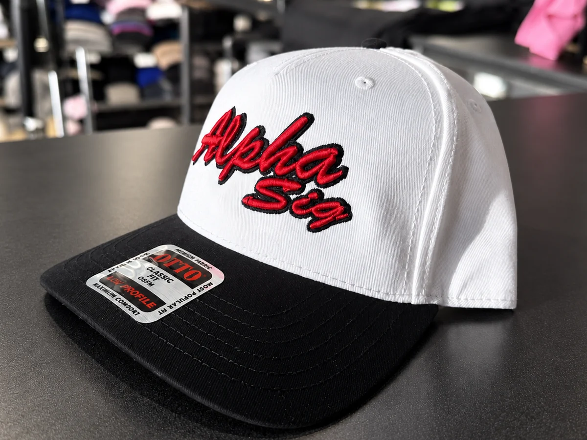 Raised puff embroidery lettering on a white and black cap