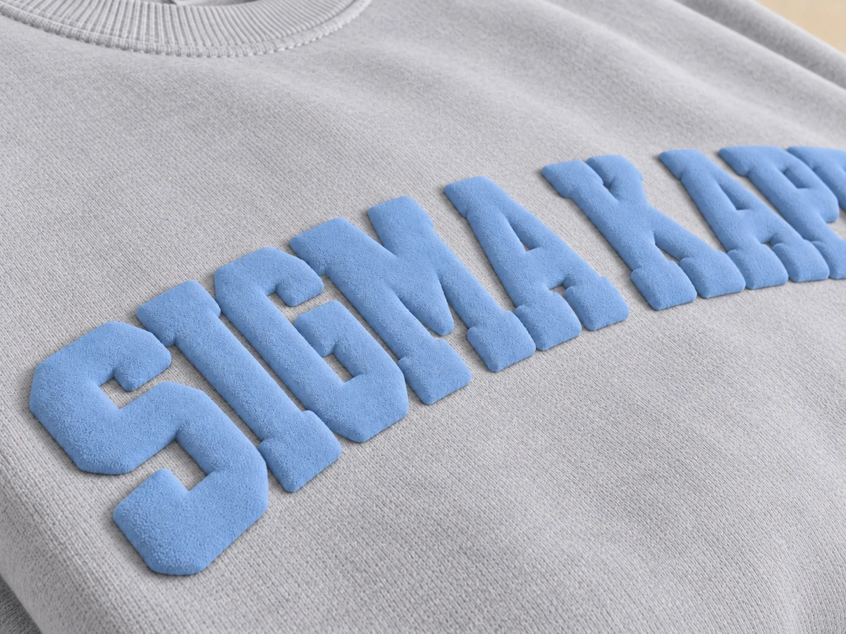 Raised light blue puff print lettering on a gray sweatshirt