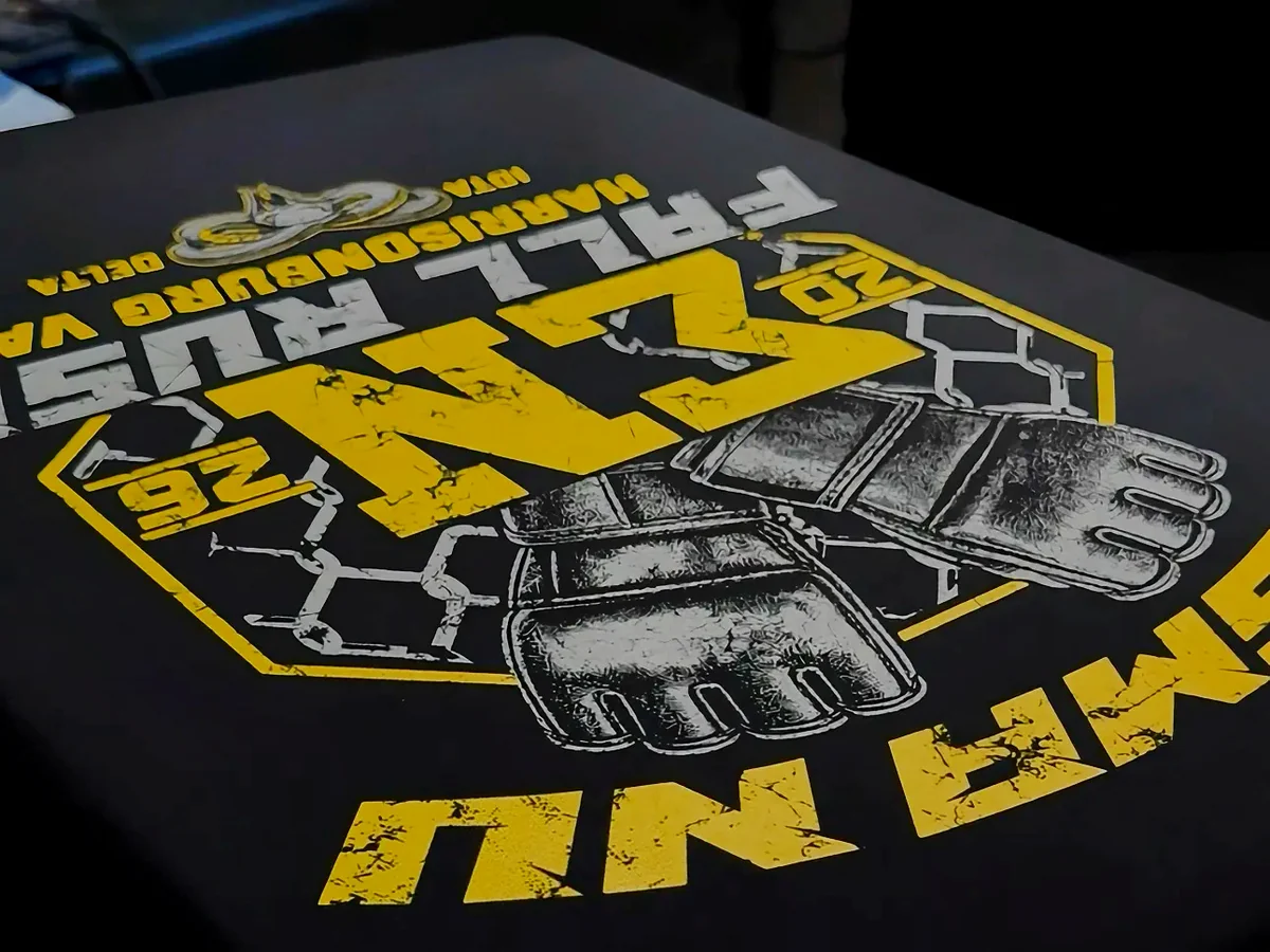 Screen-printed Sigma Nu graphic on a black tee